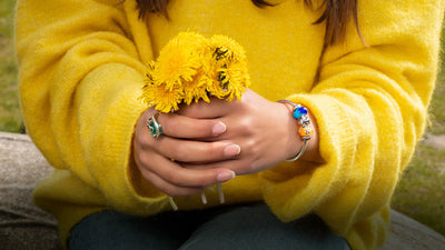 Trollbeads bangle and modle holding yellow flowers